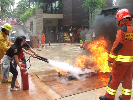 Workers at Central Festival Pattaya Beach are given training and a chance to practice putting out fires.